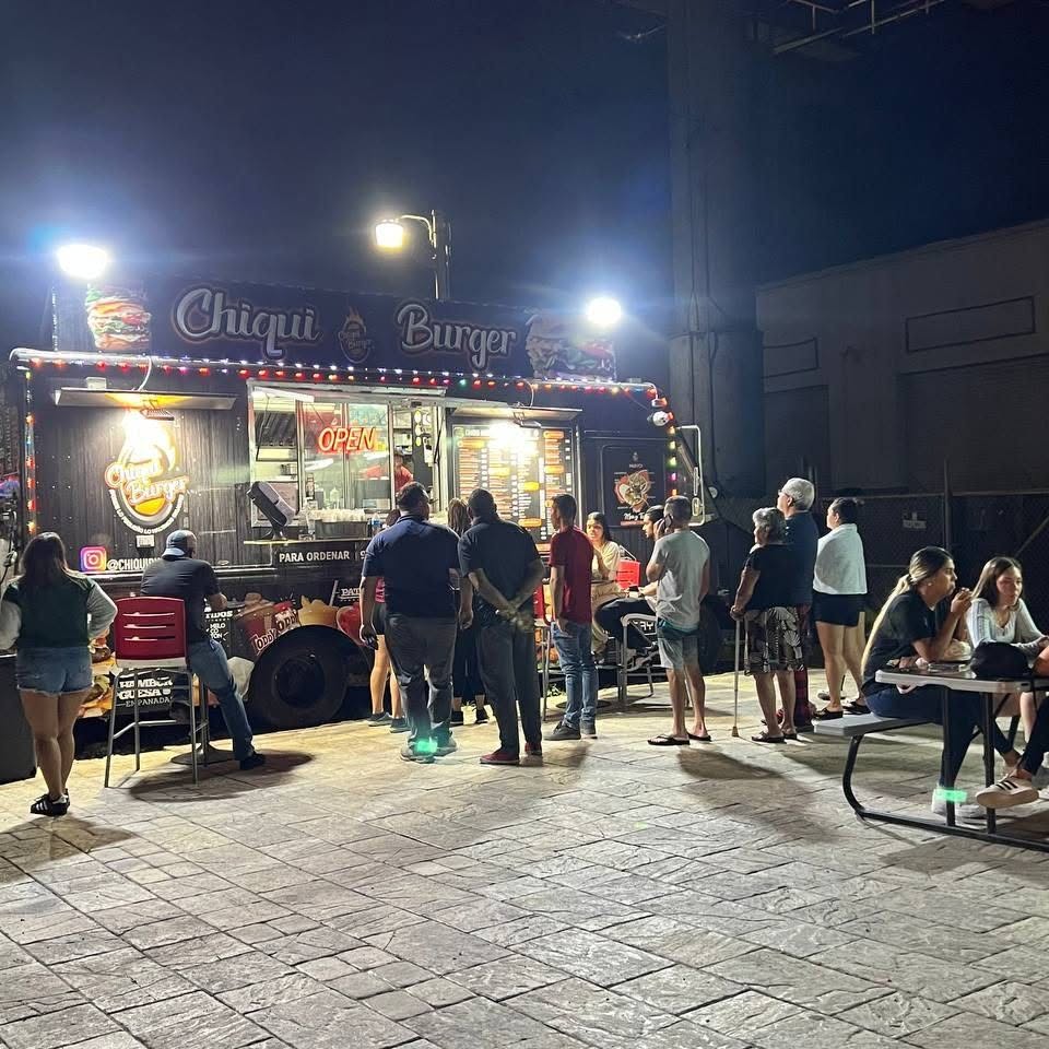 Chiqui Burger food truck lit up at night